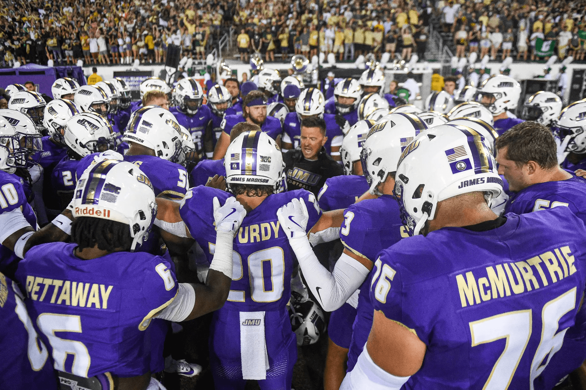 jmu players in a huddle